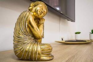 a gold statue of a woman sitting on a table at Apartamento Luna in Tías +60 photos