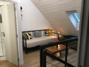 a small bedroom with a bed in a attic at Gîtes du Moulin à Tan à Saché 37 in Saché