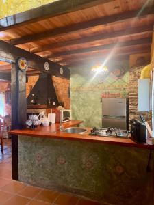 a kitchen with a counter with a sink and a stove at Casa Redonda in Ourense +66 photos