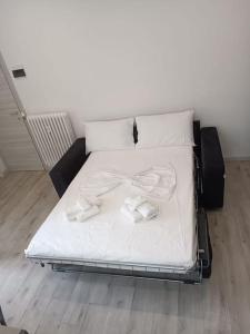 a bed with white sheets and bow ties on it at Due Rose in Recco +15 photos