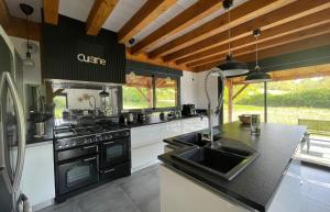 a kitchen with a sink and a stove top oven at Villa Harmonie in Nerbis