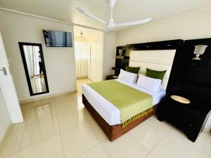 a bedroom with a large bed and a ceiling at Ts Group Africa furnished apartments - Marothwane Saturday Sebola in Pretoria