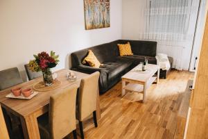 a living room with a couch and a table at Apartman Valerija in Doboj