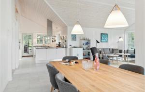 a dining room and kitchen with a table and chairs at Awesome Home In Græsted With Wifi in Græsted