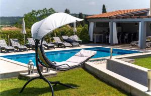 a white chair sitting next to a swimming pool at Villa Vittorio in Rovinj