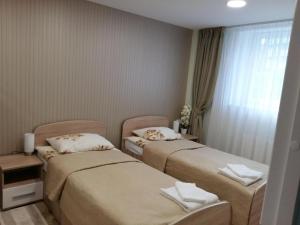 a hotel room with two beds and a window at Apartment with private entrance in Šilutė