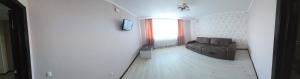 a living room with a couch and a window at Apartment on Parkovaya in Chornomorsk