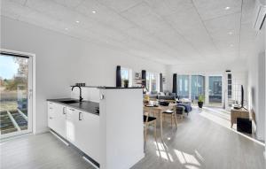 a kitchen and dining room with white walls and a table at 3 Bedroom Amazing Home In Rødby in Rødby