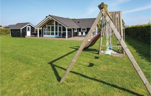 a wooden swing set in a yard in front of a house at Holiday Home Tjørnemose Sydals V in Skovby