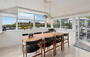 een eetkamer met een houten tafel en zwarte stoelen bij Bakkehuset in Hejls