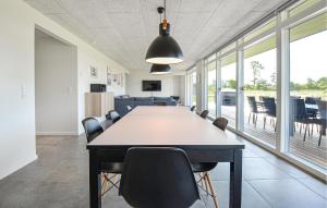 a conference room with a large table and chairs at Cozy Home In Glesborg With Wifi in Glesborg