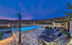 a villa with a swimming pool at night at Two-Bedroom Holiday Home In Drvenik Veli in Veliki Drvenik +33 photos