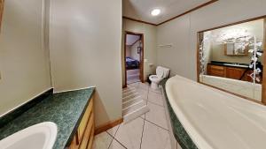 a bathroom with a tub and a sink and a toilet at Put-in-Bay Island Club #74 in Put-in-Bay