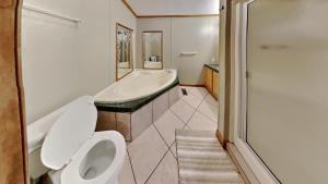 a bathroom with a toilet and a tub and a sink at Put-in-Bay Island Club #74 in Put-in-Bay