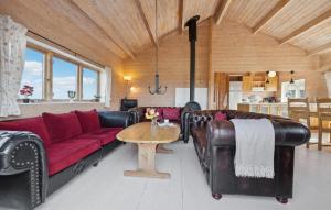 a living room with a red couch and a table at Three-Bedroom Holiday Home In Ulfborg in Ulfborg