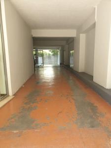 an empty hallway with an orange floor in a building at C i t y v i b e s Διαμέρισμα Α1 in Ioannina +9 photos