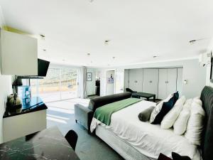 a bedroom with a bed and a couch at Hotel Vibes Cape Town Plattekloof in Cape Town