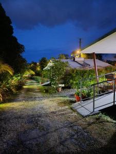 a driveway leading to a house at night at DADI'S LITTLE PARADIS in Sainte-Rose