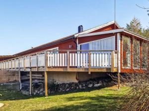 a house with a deck on the side of it at 6 person holiday home in VALDERMARSVIK in Stora Getterö