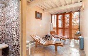 a living room with two chairs and a fireplace at Villa Monte Bottigli in Grosseto