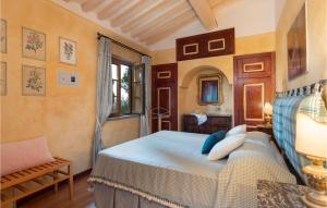 a bedroom with a bed and a chair and a window at Villa Monte Bottigli in Grosseto