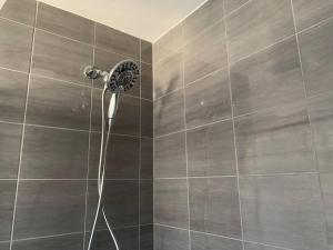 a shower with a shower head in a bathroom at Brand new house in Ottawa +14 photos