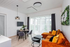 a living room with a couch and a table at Mano jūra Small rest house in Palanga