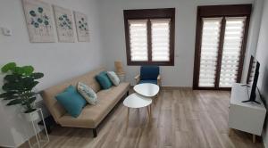 a living room with a couch and a table at El Cantillo del Jerte in Cabezuela del Valle