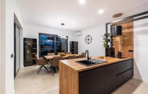 a kitchen and dining room with a dining room table at Villa Hill in Maslenica