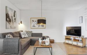 a living room with a couch and a table at Cozy Home In Gilleleje With Kitchen in Gilleleje