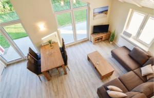 a living room with a couch and a table at Nice Home In Dagebüll With Sauna in Dagebüll
