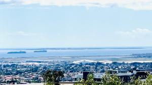 a view of a city with the ocean in the background at Hotel Vibes Cape Town Plattekloof in Cape Town