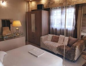 a living room with a couch and a chair at C i t y v i b e s Διαμέρισμα Α1 in Ioannina