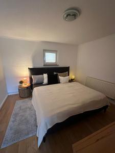 a bedroom with a large bed and a window at HappyNest in Friedrichswalde