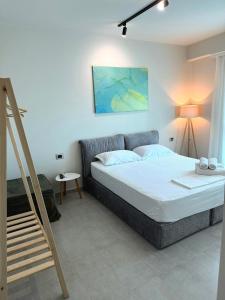 a bedroom with a bed and a staircase in it at STAY-FIVE Modern Central Studios Self Check-in & Fast Wi-Fi in Shkodër