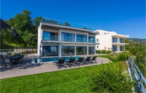 a villa with a swimming pool and lawn at Beautiful Home In Opric With Wifi in Opric