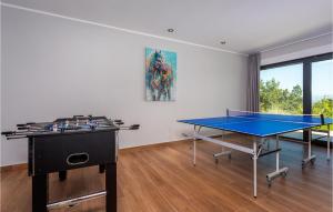 a room with two ping pong tables and a painting at Beautiful Home In Opric With Wifi in Opric