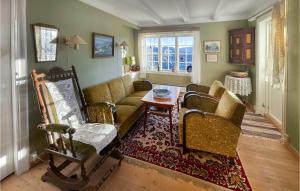 a living room with a couch and chairs and a table at 4 Bedroom Cozy Home In Svorkmo in Brattli