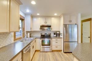 a kitchen with white cabinets and stainless steel appliances at 5 Mi to Whitefish Resort Minutes to Chairlifts! in Whitefish