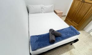 a bed with a teddy bear sitting on it at Private Room in San Ġwann