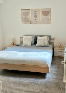 a bedroom with a large bed with blue sheets at The Lakeside Apartment - Strategic position! in Lugano