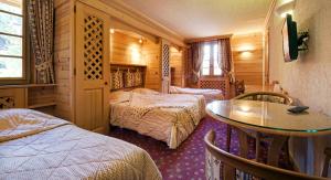 Postel nebo postele na pokoji v ubytování Hotel les Sapins
