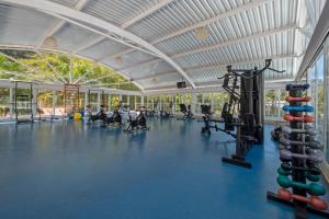 a large gym with people exercising in the gym at Villagio Embu Resort & Convention in Embu