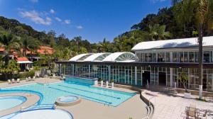 a resort with a swimming pool and a building at Villagio Embu Resort & Convention in Embu