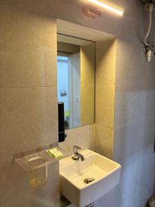 a bathroom with a sink and a mirror at Terracotta Trails-1 Bedroom with Living room in Varanasi +20 photos