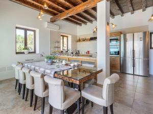 a kitchen with a dining room table and chairs at Holiday home with children play area in Santa Eularia des Riu