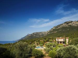 an aerial view of a house with mountains in the background at Holiday home with spacious lounge area in Banyalbufar
