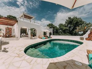 a house with a swimming pool in a yard at Holiday Home in Ibiza near Las Salinas Beach in Cala Vadella
