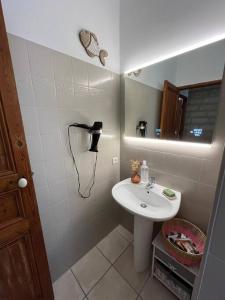 a bathroom with a sink and a phone on the wall at jolie maison de pêcheurs in Palavas-les-Flots +24 photos