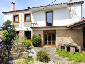 a large white house with windows and a yard at A Vixía do Roncudo in Corme-Puerto